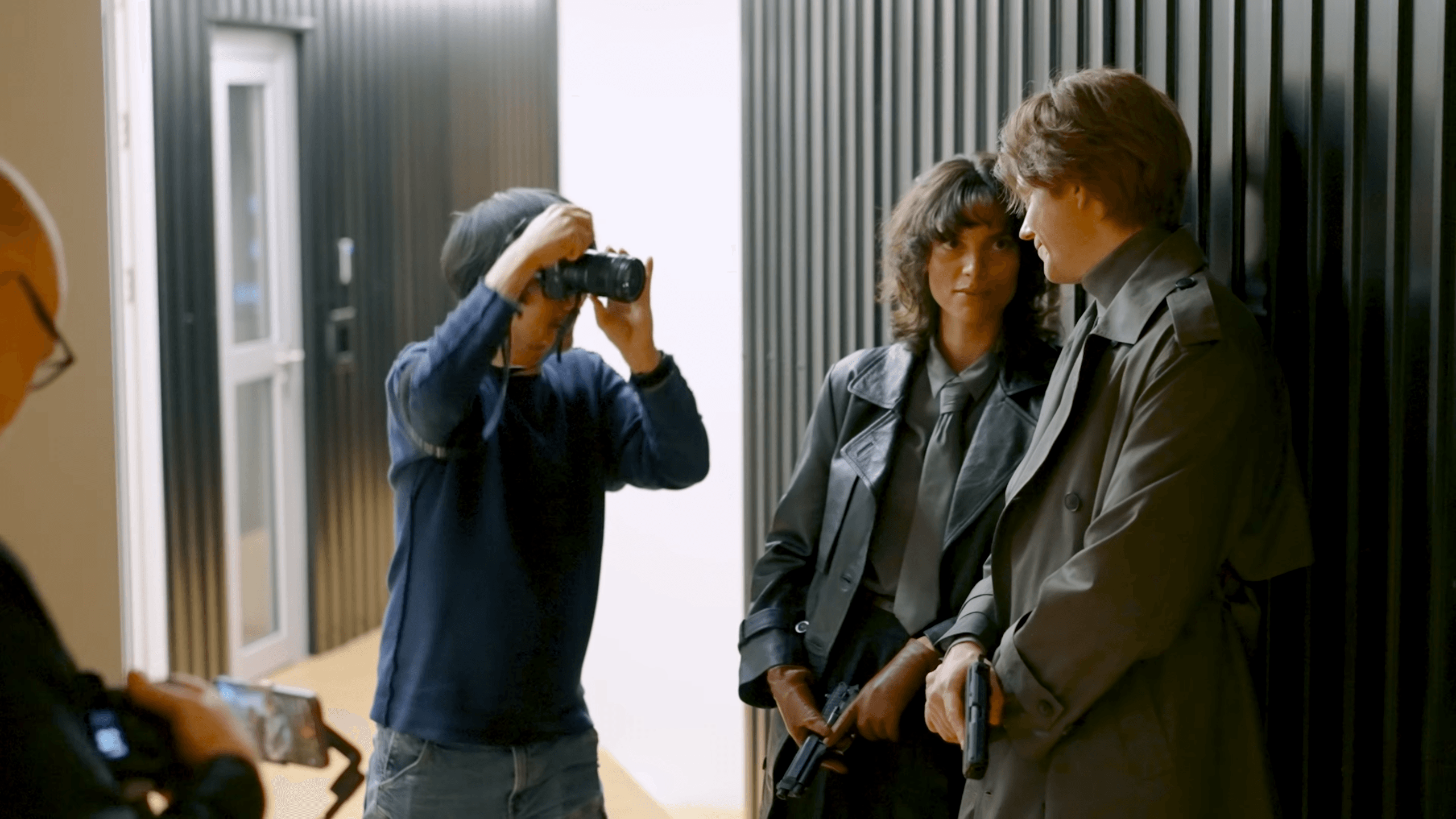 Hideo Kojima taking a photo of charlee fraser and bill skarsgard for Physint cover art