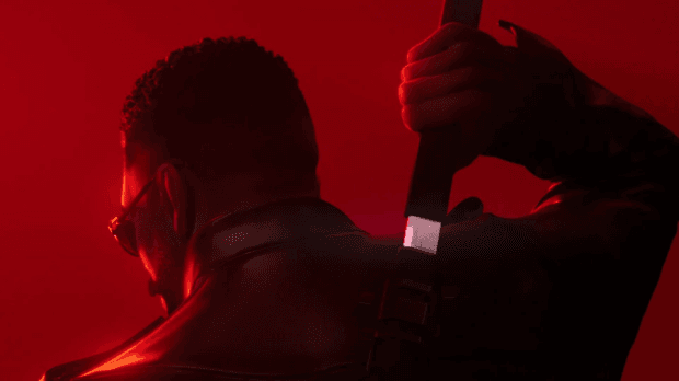 Red-lit Marvel's Blade artwork shows Blade from behind in sunglasses and a leather jacket, gripping a sword over his shoulder.